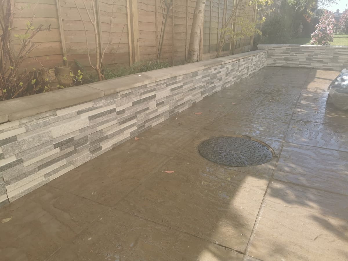 After: Old sleeper wall to a stone-clad retaining wall
