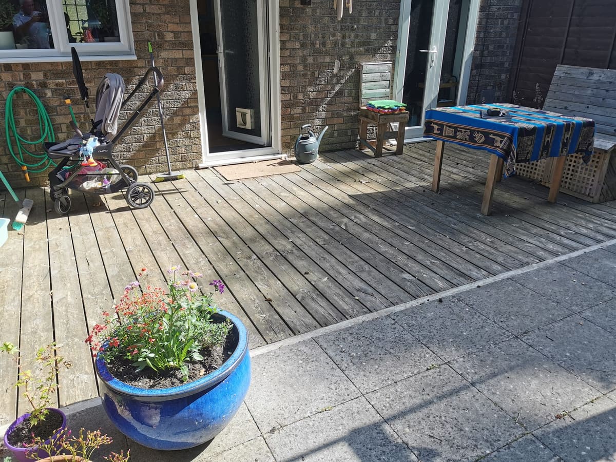 Before: Tired decking and old slabs to restored decking and new turf