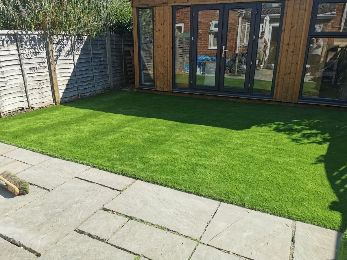 After: Grass matting in front of a garden room to artificial grass