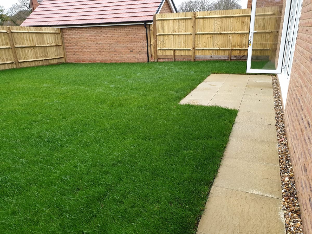 Before: New-build lawn to a landscaped garden with a pebble stream, raised beds and paving