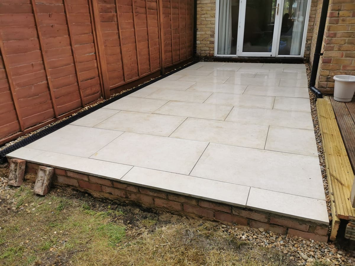 After: Bare ground by the house to a raised porcelain patio