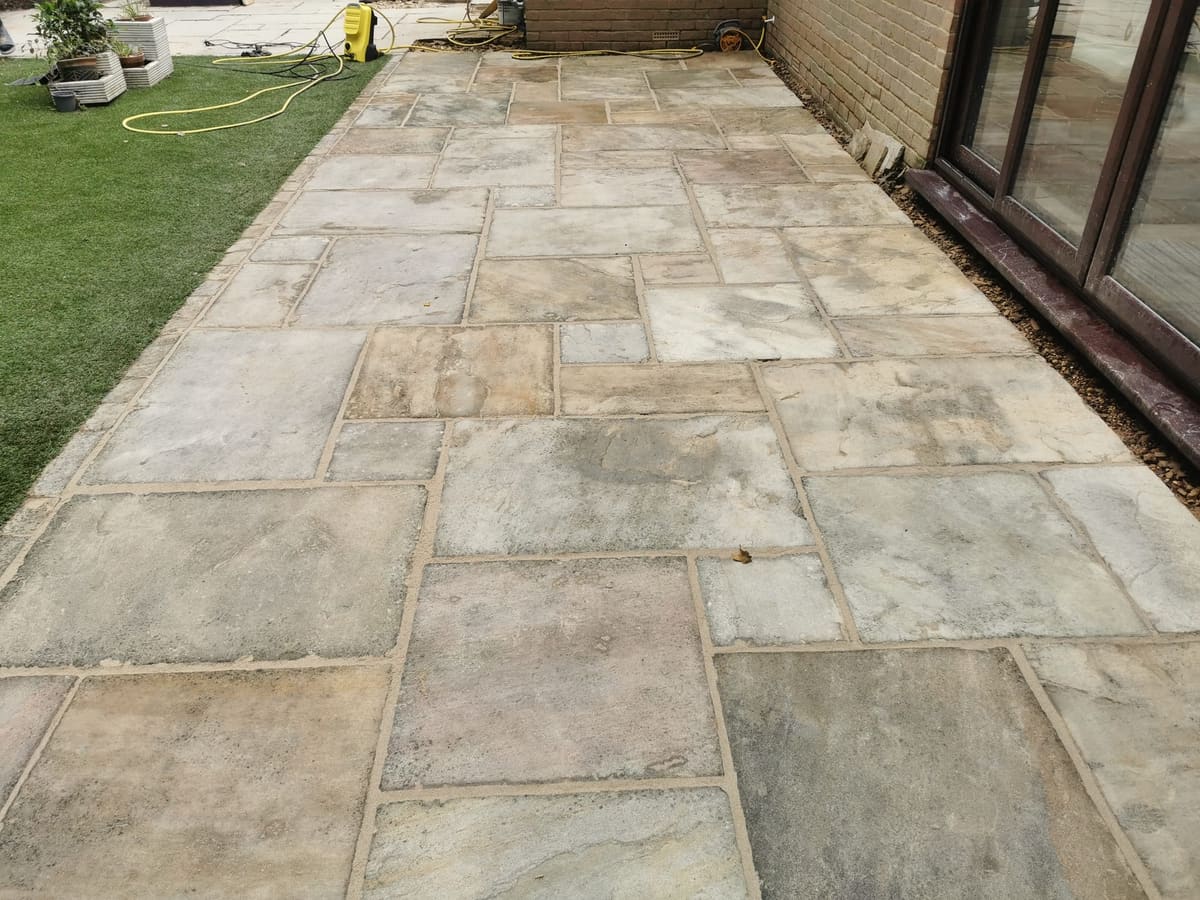 After: Weathered sandstone patio, cleaned and refurbished