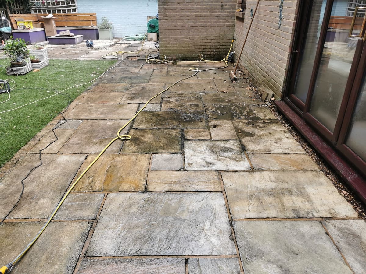 Before: Weathered sandstone patio, cleaned and refurbished