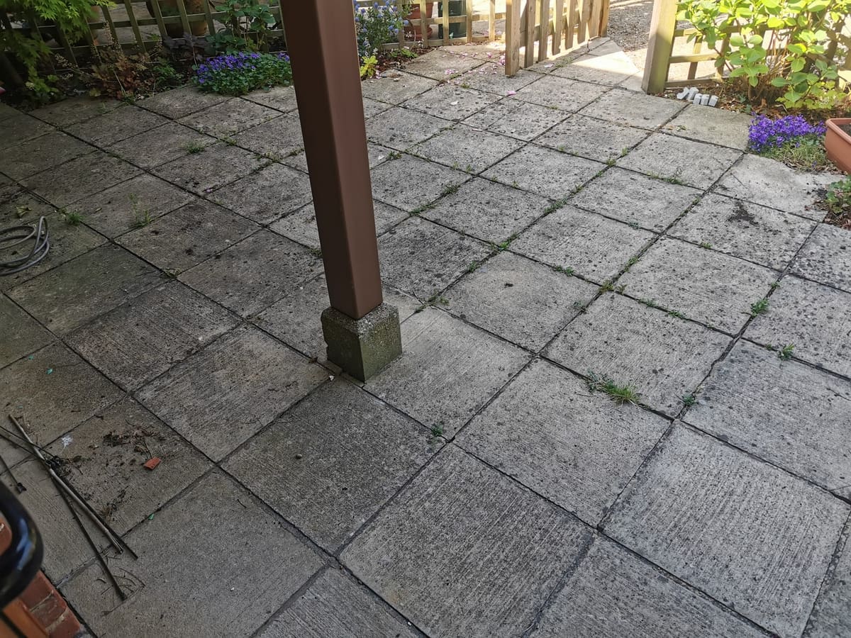 Before: Grey slab patio, cleaned