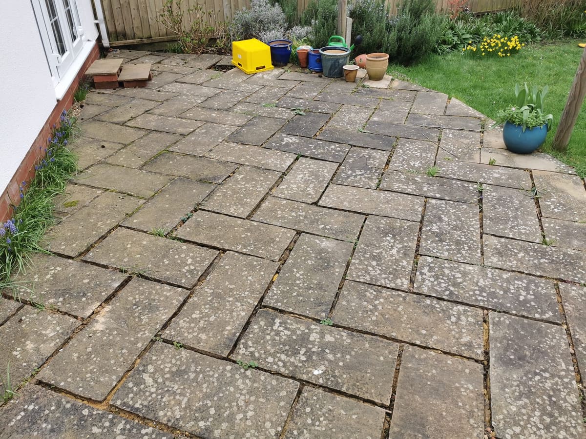 Before: Weathered patio, cleaned and refurbished