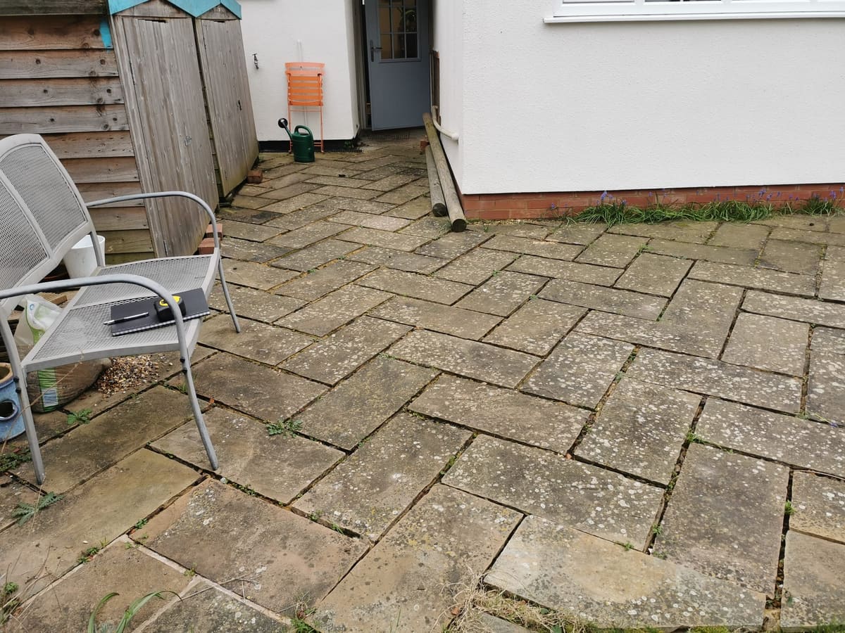 Before: Worn old paving relaid in sandstone