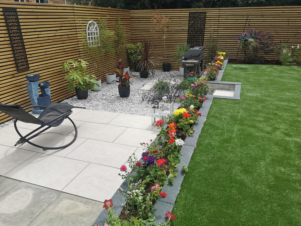 Finished: porcelain patio, planted border and new lawn
