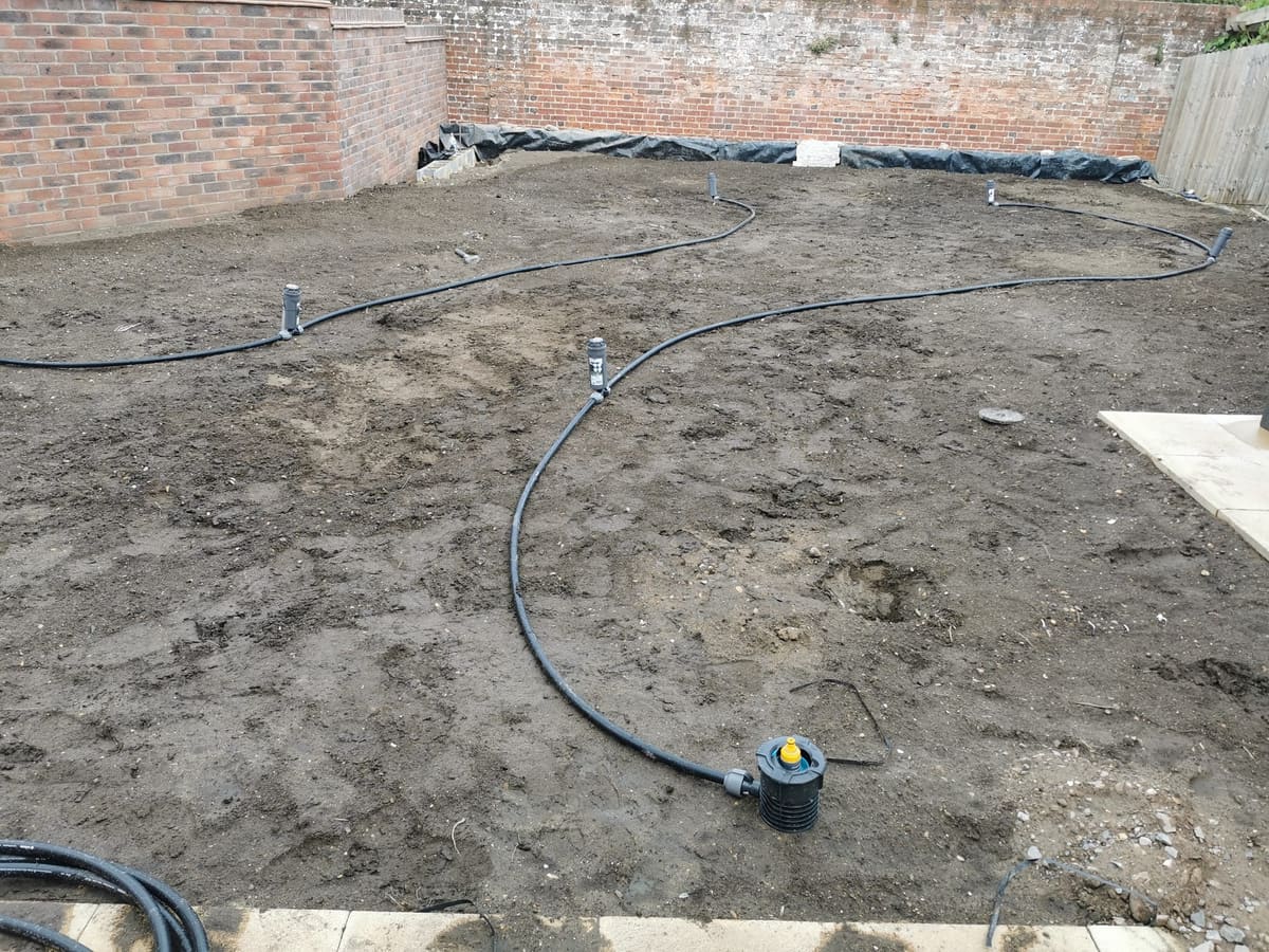 Old lawn dug out, with the pipe and pop-up heads set out